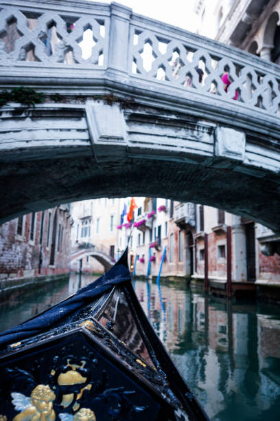 istock Gondola gliding under a bridge in Venice 846559096