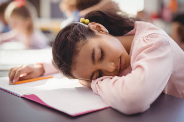 istock Tired schoolgirl sleeping in classroom 846567582