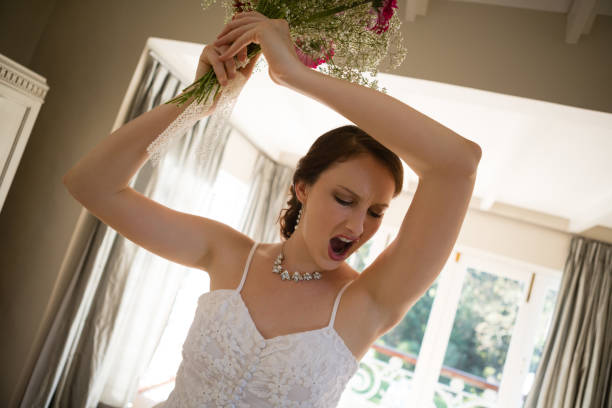 istock Tilt image of angry bride throwing bouquet at home 846573206