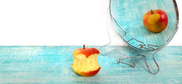 istock Bit of apple and reflection in a mirror of the whole apple 846573242