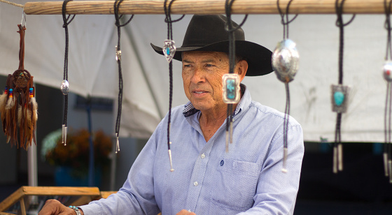 Santa Fe, NM, USA: A man in a cowboy hat sells turquoise Native American-made bolo ties at the Santa Fe Fiesta, a week-long event commemorating Diego de Vargas' 1692 reconquest of Santa Fe.