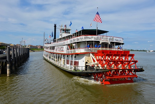 New Orleans, Louisiana, USA - September 2, 2017: the vintage steamboat Natchez docking at the port of New Orleans, Louisiana. Built as a tourist cruise boat along the Mississippi. A popular tourist activity in New Orleans is to cruise on a steamboat along the Mississippi River.