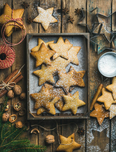 istock Gingerbread star shaped cookies in wooden tray with baking paper 846579966