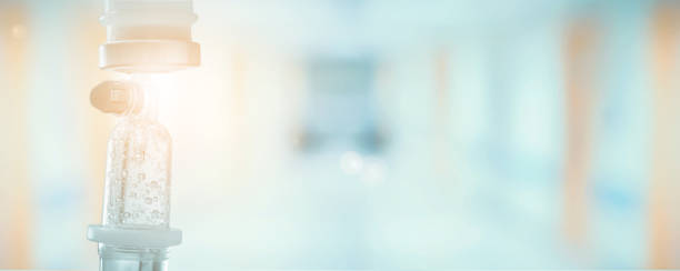istock Medical drip with hospital blurred background 846584252