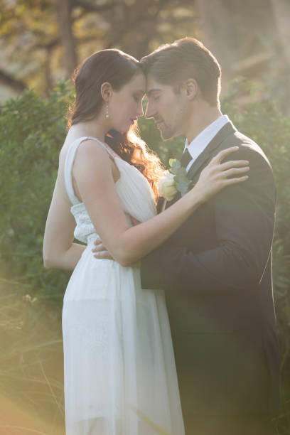 istock Romantic newlywed couple with eyes closed standing at park 846590542