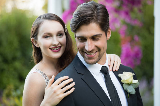 istock Beautiful bride with bridegroom standing in park 846590732