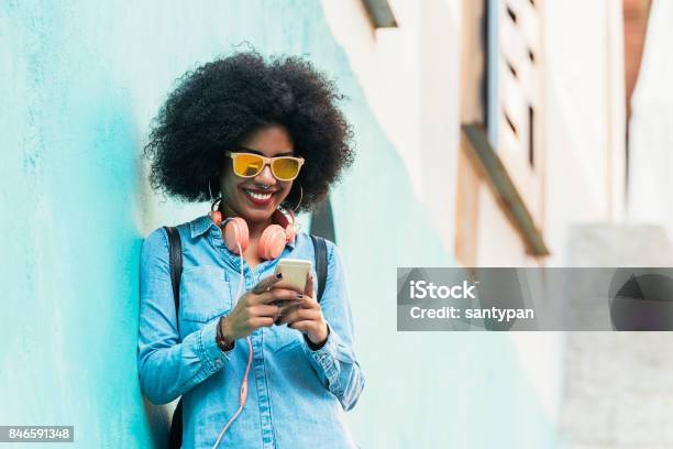 Beautiful Afro American Woman Using Mobile In The Street Stock Photo - Download Image Now