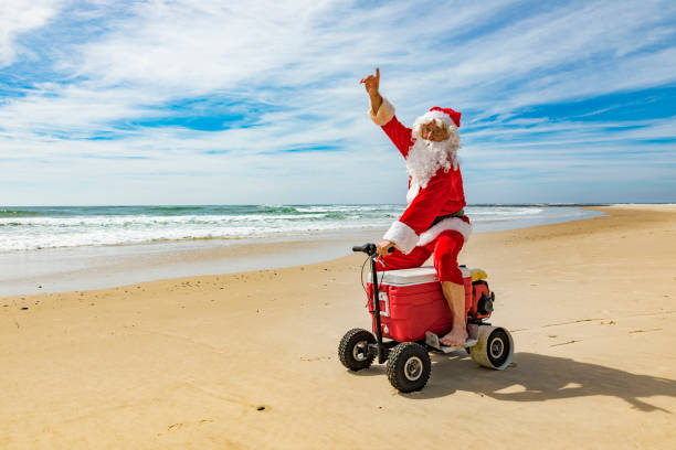 istock Santa Claus Riding a Motorised Esky Cooler on the Beach 846599258