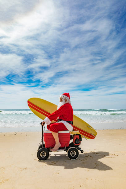 istock Santa Claus Riding a Motorised Esky Cooler on the Beach 846599260