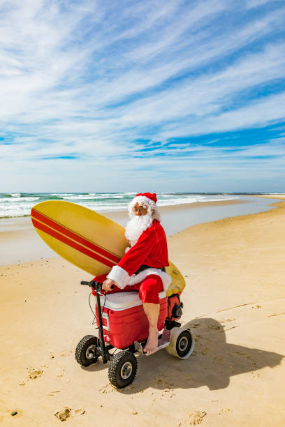 istock Santa Claus Riding a Motorised Esky Cooler on the Beach 846599262