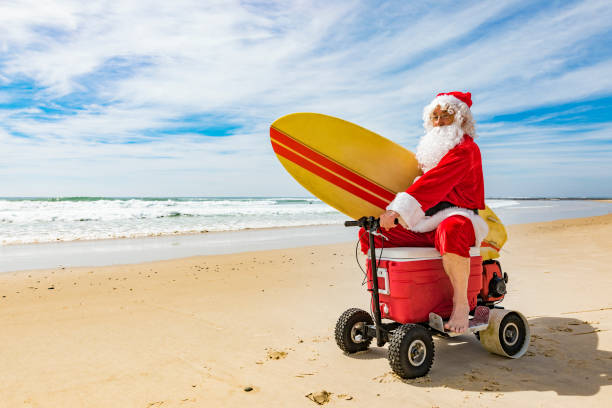 istock Santa Claus Riding a Motorised Esky Cooler on the Beach 846599264