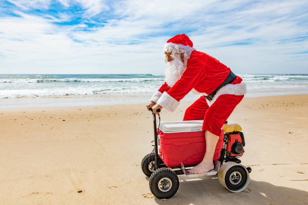 istock Santa Claus Riding a Motorised Esky Cooler on the Beach 846599266