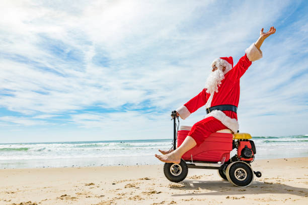 istock Santa Claus Doing a Wheelie on a Motorised Esky Cooler on the Beach 846599270