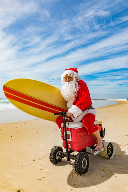 istock Santa Claus Riding a Motorised Esky Cooler on the Beach 846599276