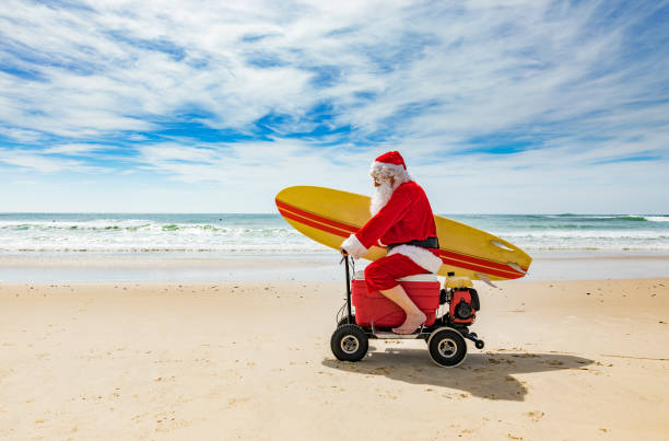 istock Santa Claus Riding a Motorised Esky Cooler on the Beach 846599278
