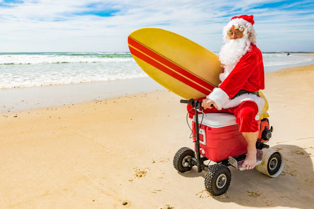 istock Santa Claus Riding a Motorised Esky Cooler on the Beach 846599280