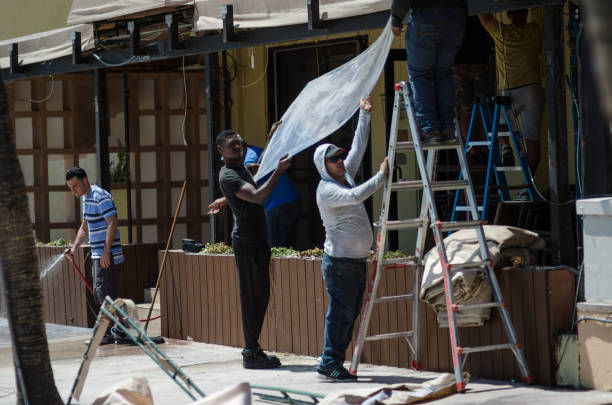 Miami - September 12, 2017: Workers repair a roof in the historic Art Deco neighborhood on Ocean Drive damaged in Hurricane Irma.