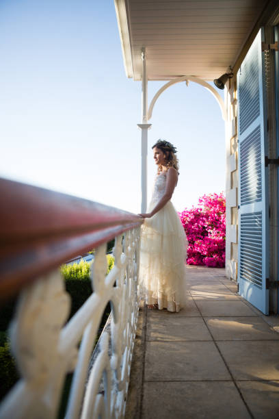 istock Beautiful bride standing by railing in balcony 846608892