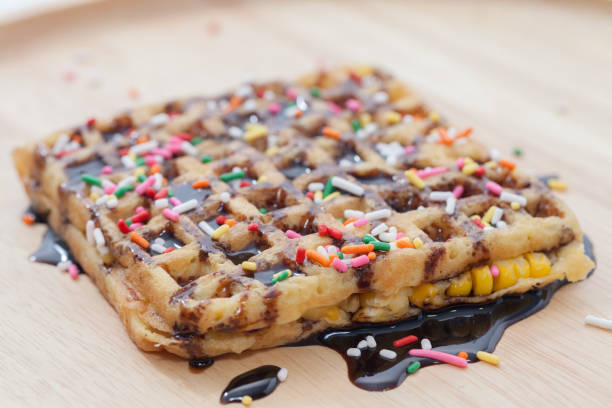 istock Waffles with melted chocolate on wooden plate 846612778