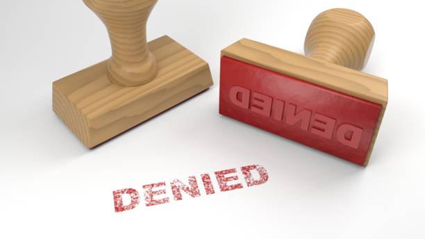 Two rubber stamps with the word denied on white rejection concept stock photo