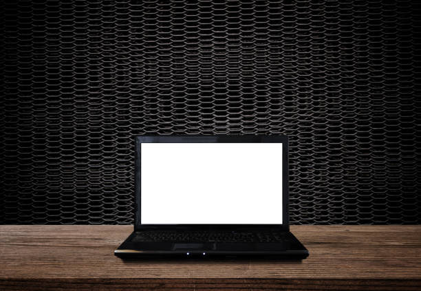 Laptop computer with blank screen, on wood table and black metal background