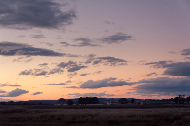 istock Sunset over country field with light clouds in the sky 846629830
