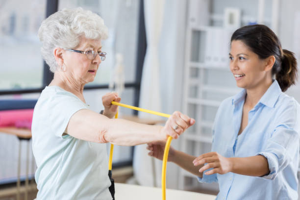 istock Senior woman pulls resistance band in physical therapy 846633158