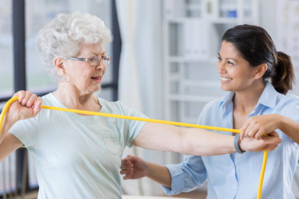 istock Senior physical therapy client uses resistance band 846633166