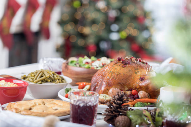 Christmas dinner table full of traditional fare in a decorated home
