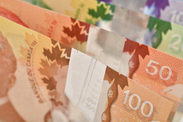 Close up of Canadian banknotes (CAD) background Close up of Canadian banknotes (CAD) background, this is polymer money with holograms that will last longer and be harder to counterfeit. over 100 photos stock pictures, royalty-free photos & images