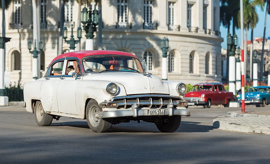 Havana: American white red Chevrolet classic car drived on the main street in Havana City Cuba - Serie Cuba Reportage