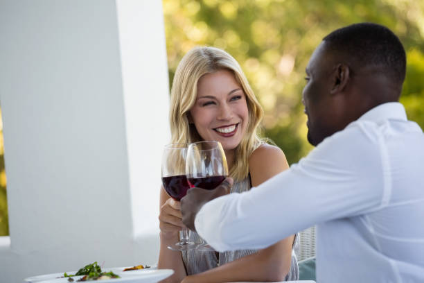 istock Happy young couple toasting wineglasses at restaurant 846637272