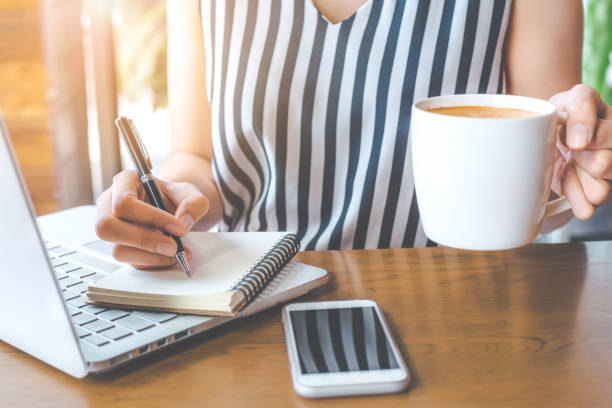 istock Business woman hand is writing on a note pad with a pen. 846643090