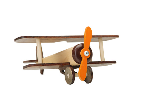 Wooden toy airplane isolated on white, close-up of an eco-friendly product for children's games, isolated on a white background. A developing toy airplane. Fight simulation.