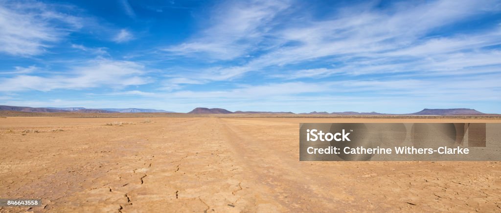 Northern Cape Landscape A dirt track leads through Northern Cape desert landscape, Southern Africa Horizon Stock Photo
