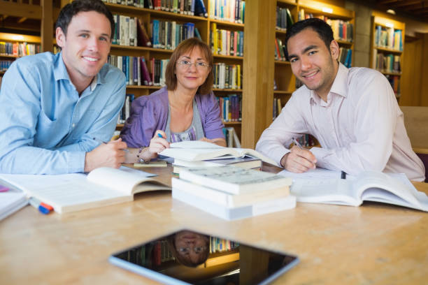 istock Mature students studying together in the library 846645710