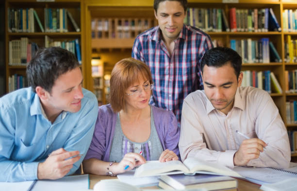 istock Adult students studying together in the library 846645810