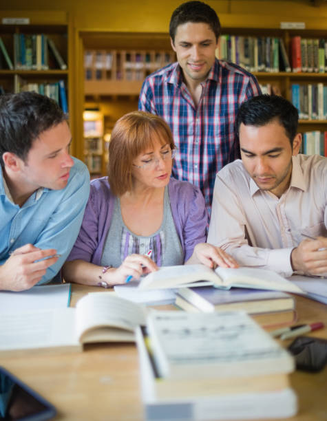 istock Adult students studying together in the library 846645838