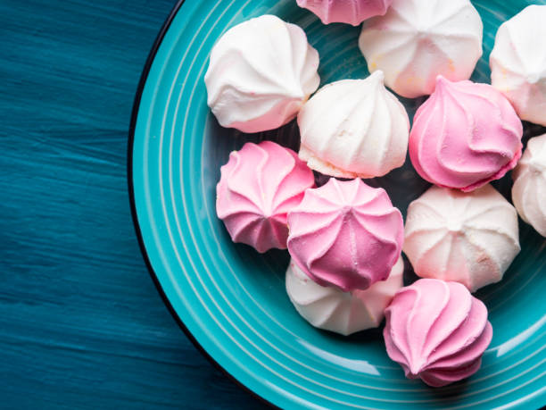 istock Pastel color meringue on green 846650744