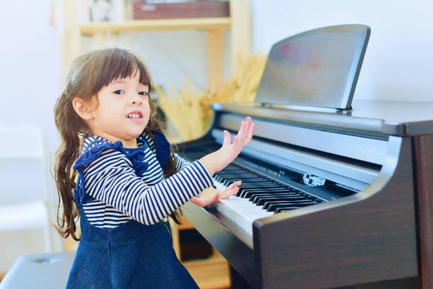istock Little girl playing the piano. 846654232