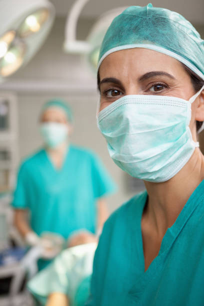 istock Smiling surgeon standing in front of a colleague 846656452