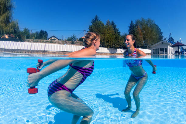 istock Women exercising with dumbbells in swimming pool 846657954