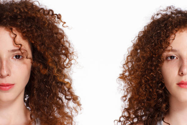 Beautiful redhead twin girls. White background.