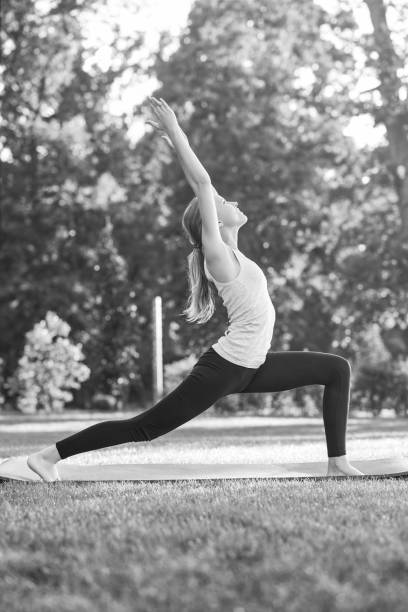 istock Young woman practicing yoga outdoors at the park 846665448
