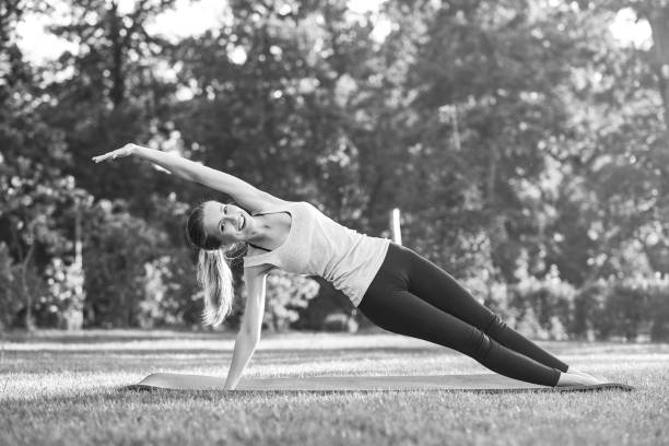 istock Young woman practicing yoga outdoors at the park 846667554
