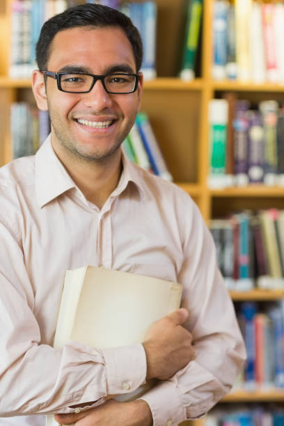 istock Smiling mature student against bookshelf in library 846671598