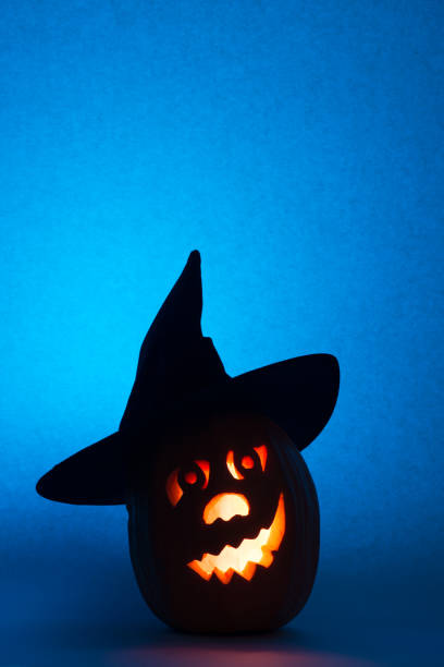 istock Happy Halloween pumpkin with a candlestick, funny face face on a blue background 846675580