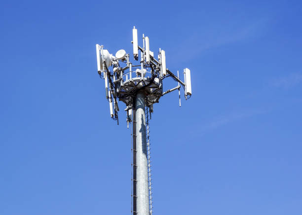 istock Top part of cell phone communication tower with multiple antennas against a blue sky 846678960