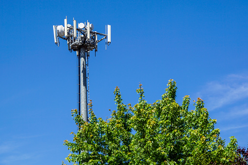 Telecommunications towers are located on the cloud forest and beautiful sky background.