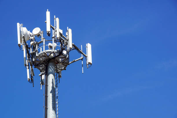 istock Top part of cell phone communication tower with multiple antennas against a blue sky 846681940